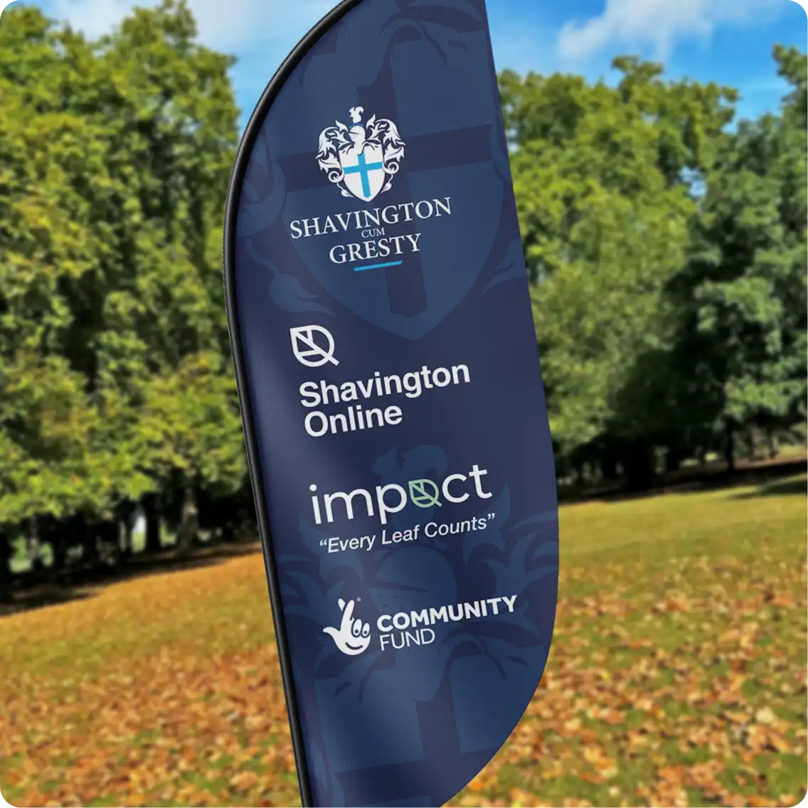 A Shavington Parish Council flag banner in a park