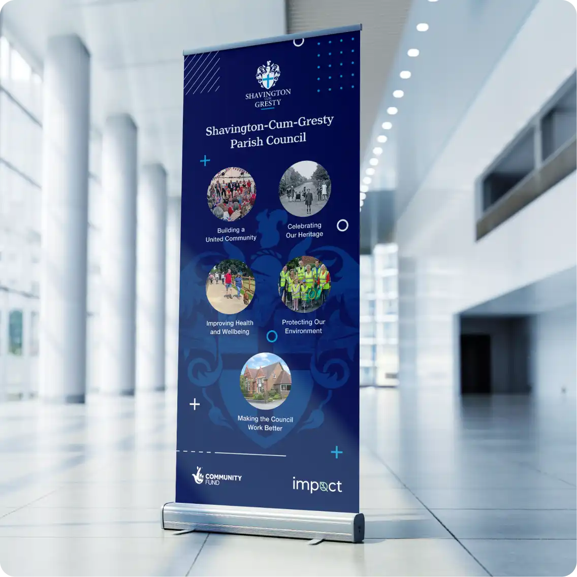 A Shavington Parish Council roll up banner in a large hallway